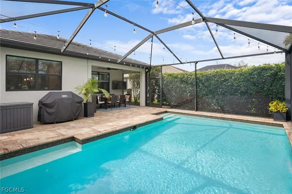 a swimming pool with patio outdoor seating and yard