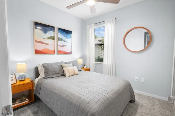 a bedroom with a bed and a painting on the wall