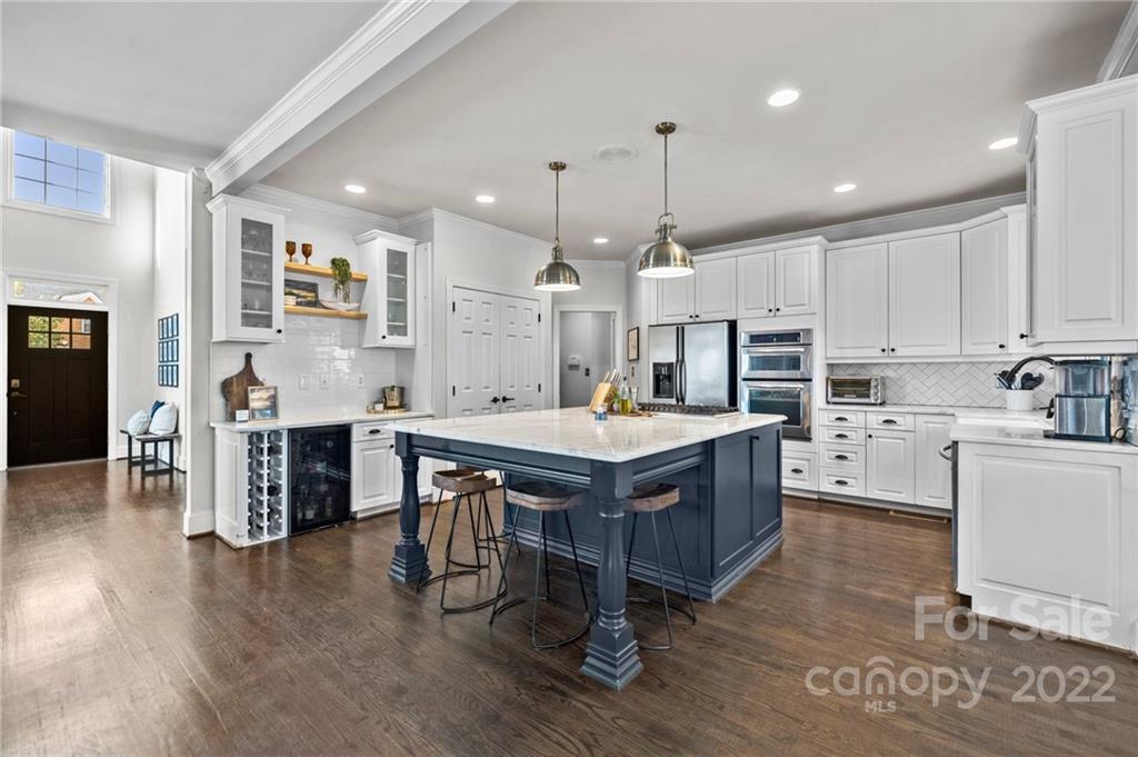 166 Lake Pointe Drive Fort Mill, SC 29708 - Photo 21 of 42 a large kitchen with kitchen island a wooden floor a center island and stainless steel appliances