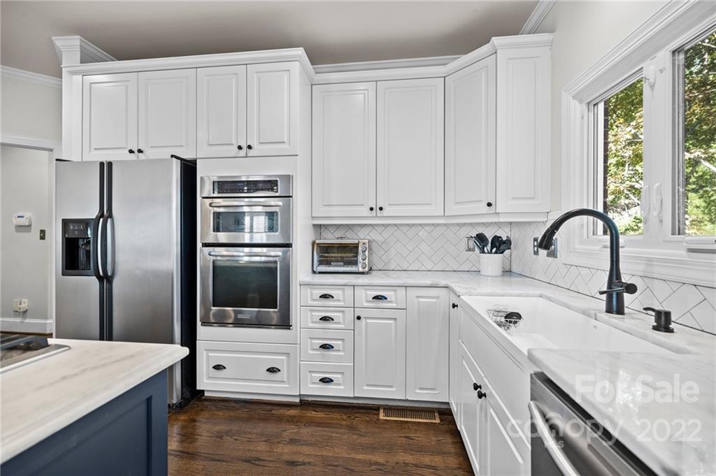 166 Lake Pointe Drive Fort Mill, SC 29708 - Photo 23 of 42 a kitchen with granite countertop white cabinets and stainless steel appliances