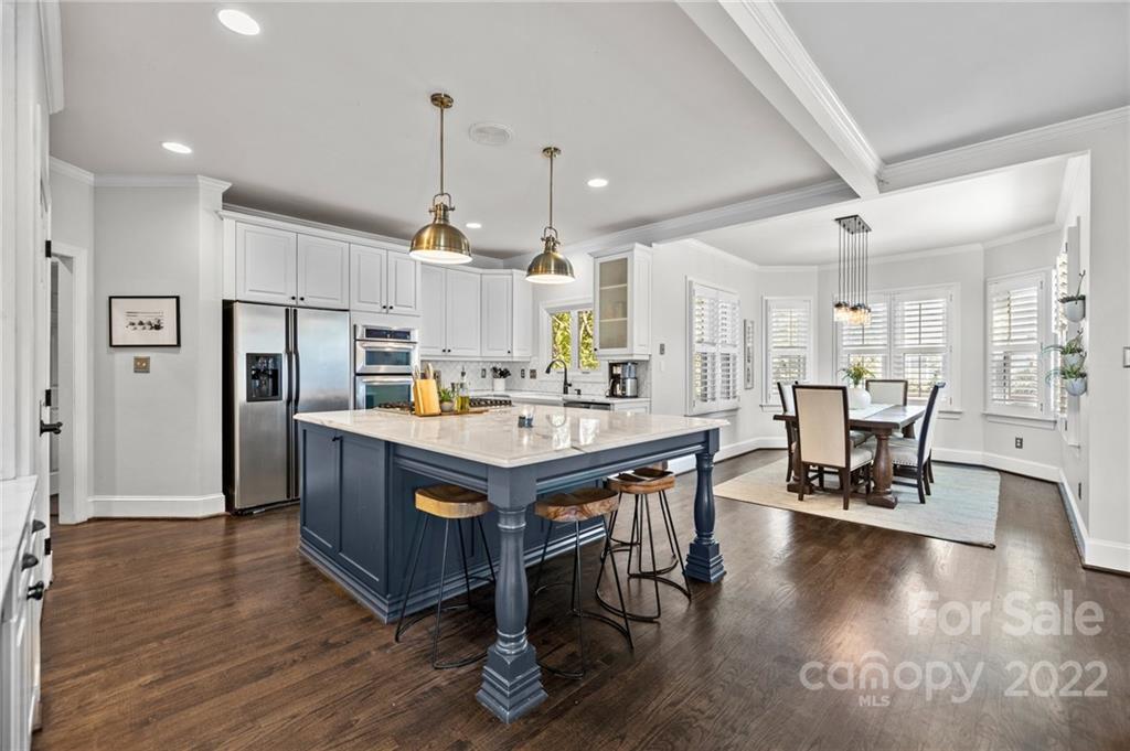 166 Lake Pointe Drive Fort Mill, SC 29708 - Photo 24 of 42 a kitchen with stainless steel appliances kitchen island granite countertop a table chairs and a refrigerator