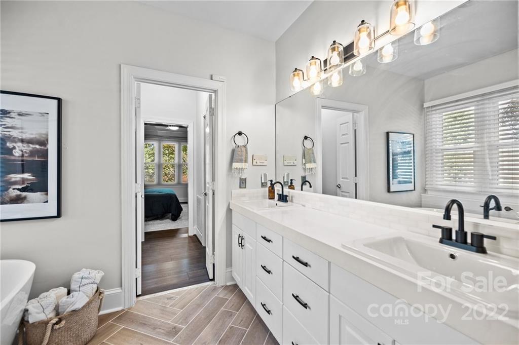 166 Lake Pointe Drive Fort Mill, SC 29708 - Photo 32 of 42 a spacious en suite bathroom with a double vanity sink and mirror