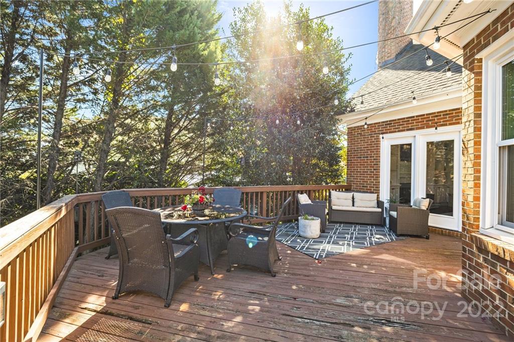 166 Lake Pointe Drive Fort Mill, SC 29708 - Photo 10 of 42 a view of a patio with dining table and chairs with wooden floor and fence
