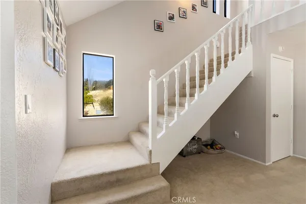 a bedroom with a bed and a dresser next to a window
