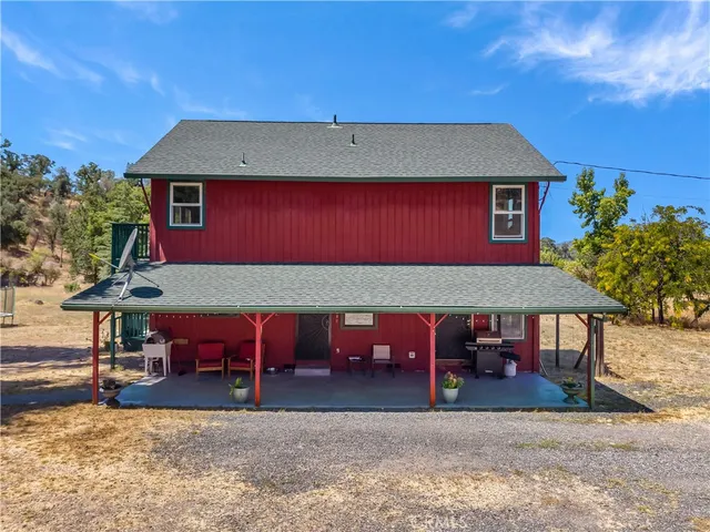 a backyard of a house with outdoor seating