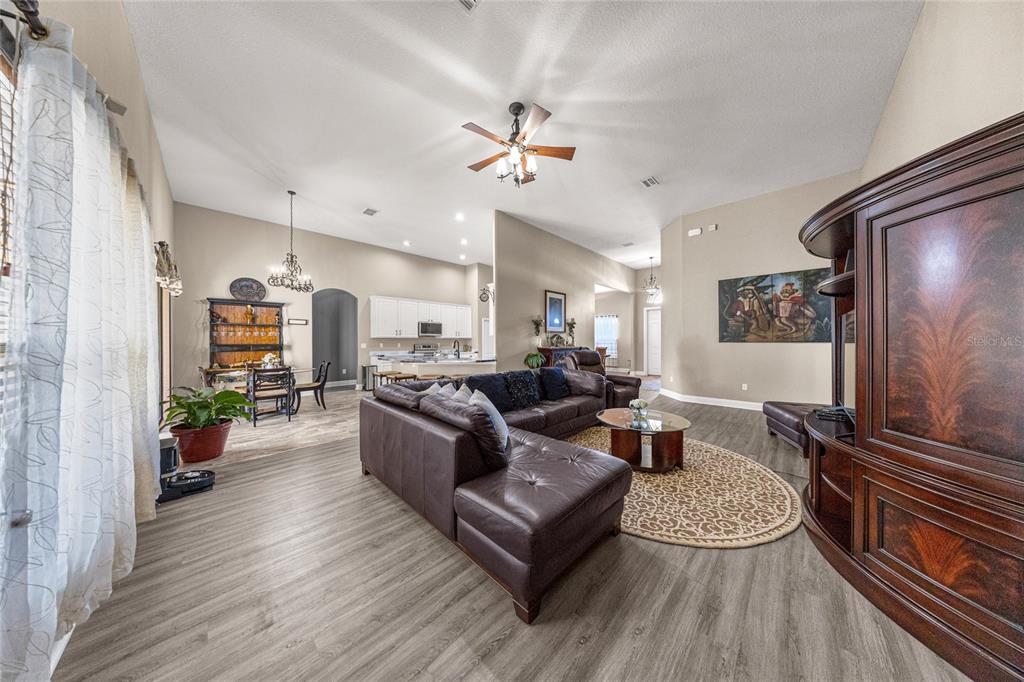 4590 Southwest 111th Place Ocala, FL 34476 - Photo 12 of 36 a living room with furniture and a flat screen tv