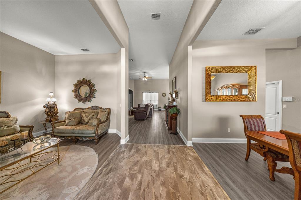 4590 Southwest 111th Place Ocala, FL 34476 - Photo 13 of 36 a living room with furniture and a wooden floor