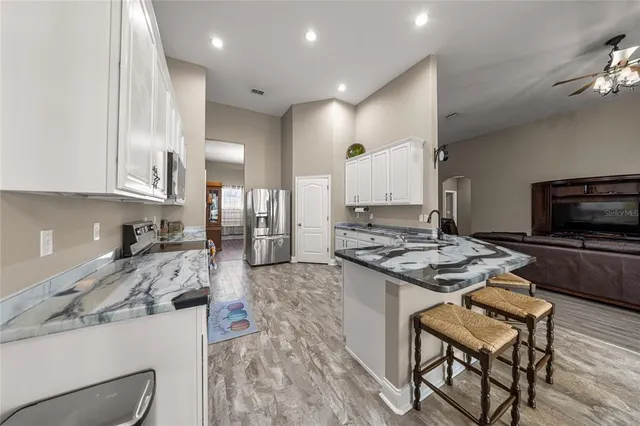 a kitchen with a stove a sink and a refrigerator