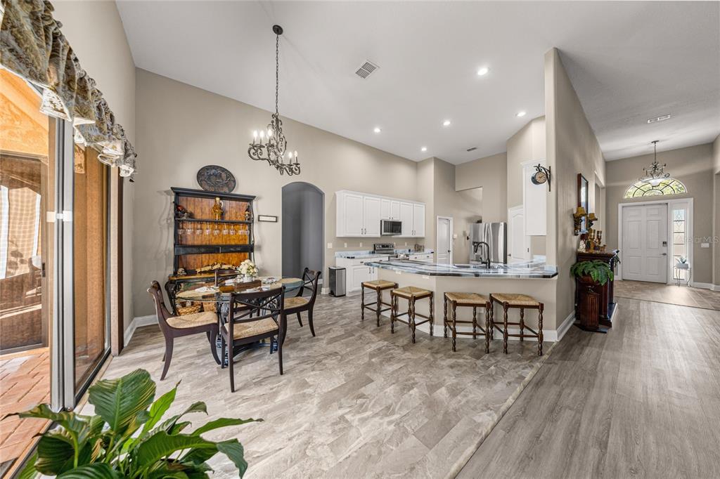 4590 Southwest 111th Place Ocala, FL 34476 - Photo 17 of 36 a view of a dining room with furniture window and wooden floor