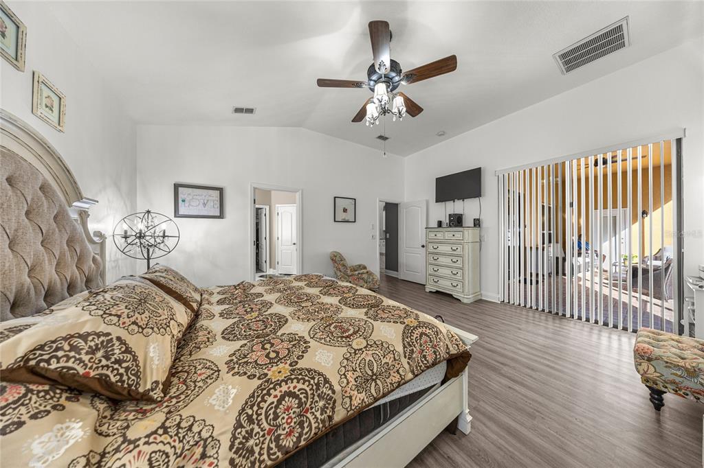 4590 Southwest 111th Place Ocala, FL 34476 - Photo 21 of 36 a bed sitting in a spacious bedroom next to a window