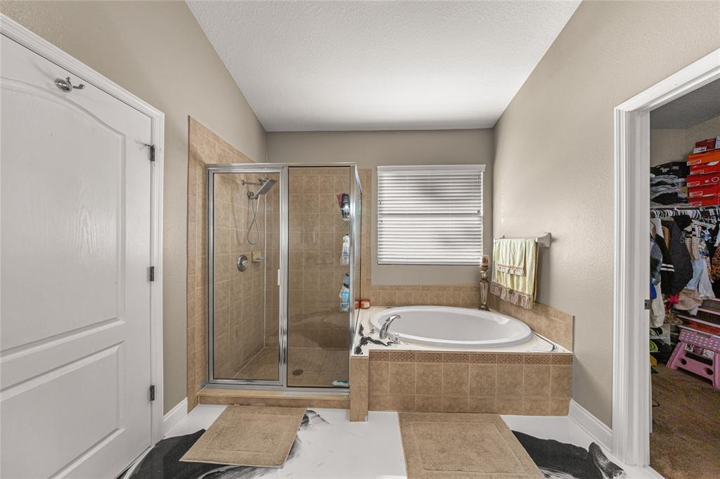 4590 Southwest 111th Place Ocala, FL 34476 - Photo 23 of 36 a bathroom with a tub shower sink and mirror