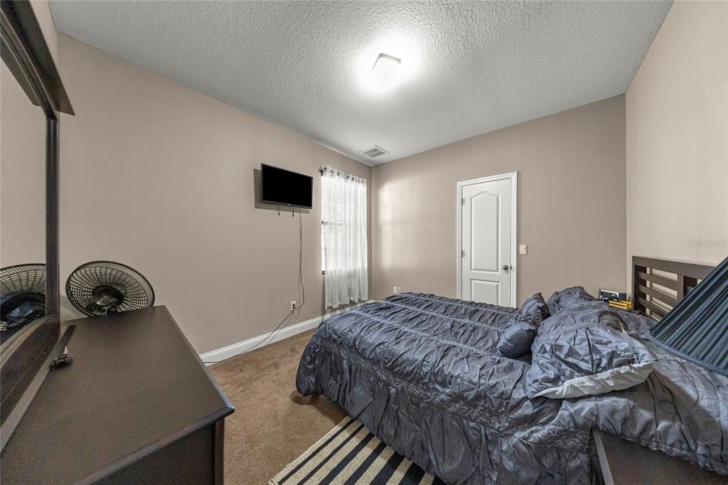 4590 Southwest 111th Place Ocala, FL 34476 - Photo 28 of 36 a bedroom with a bed and a window