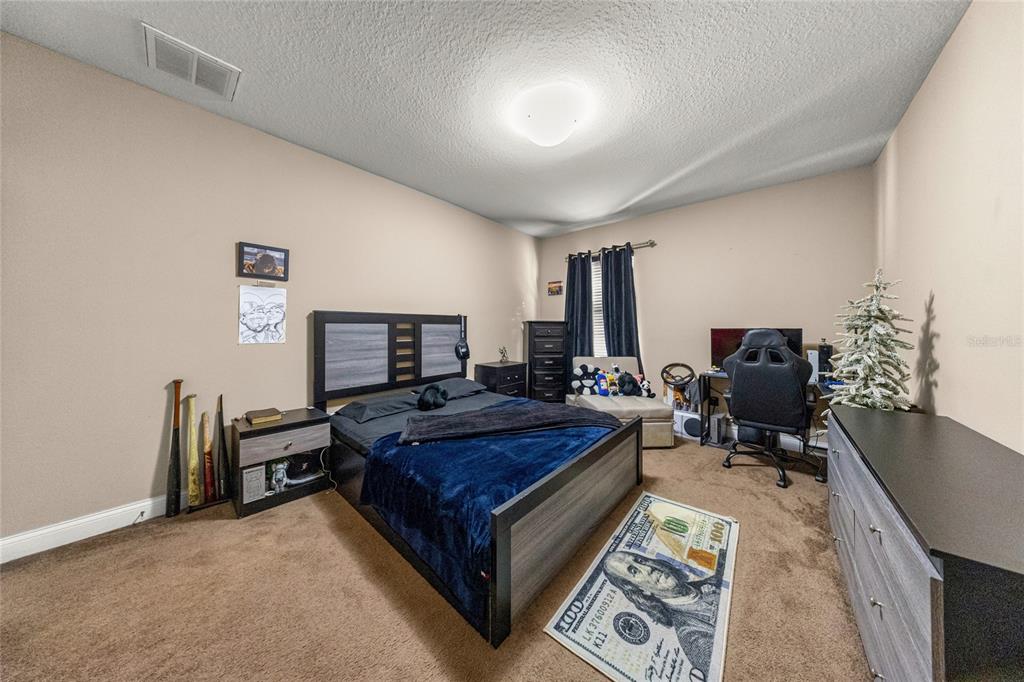 4590 Southwest 111th Place Ocala, FL 34476 - Photo 29 of 36 a living room with furniture and a flat screen tv