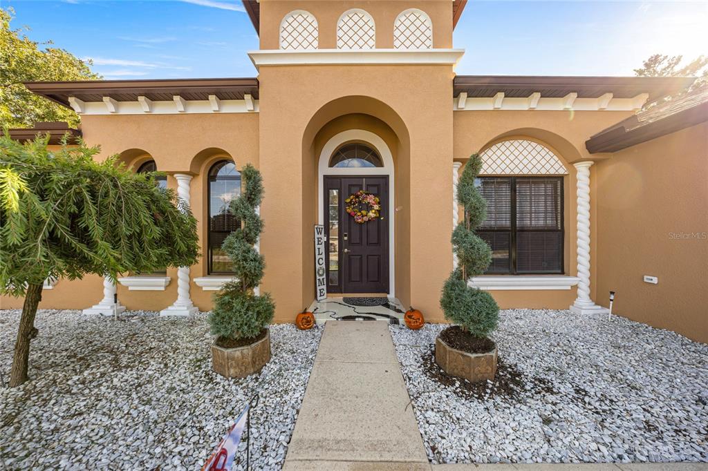 4590 Southwest 111th Place Ocala, FL 34476 - Photo 9 of 36 a front view of a house with garden