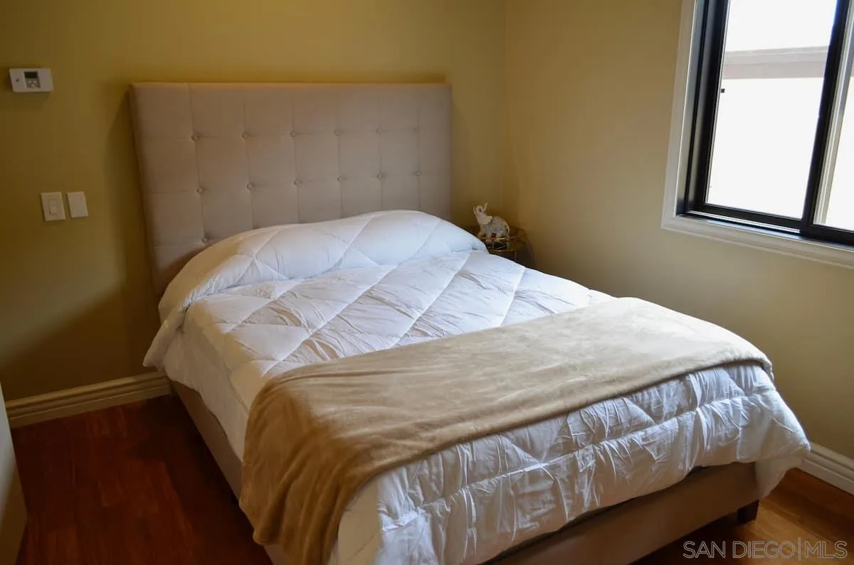 1235 Neptune Avenue Encinitas, CA 92024 - Photo 6 of 32 a bed sitting in a bedroom next to a window
