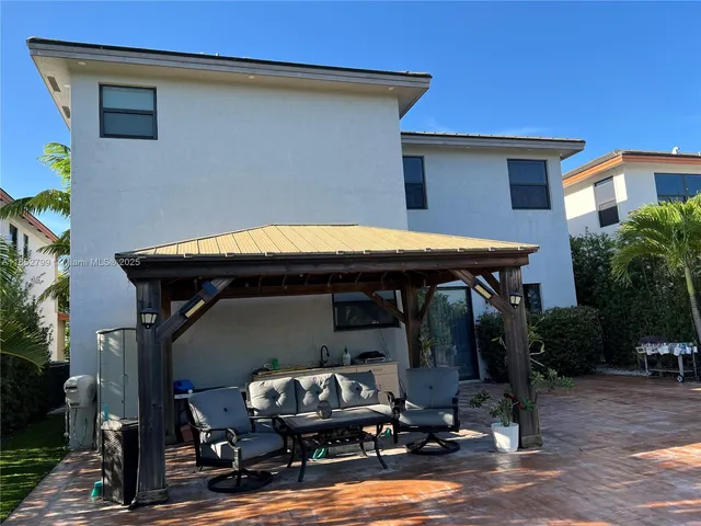 a view of a chairs and table in the patio