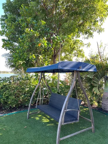 a view of a swimming pool with lounge chairs in patio