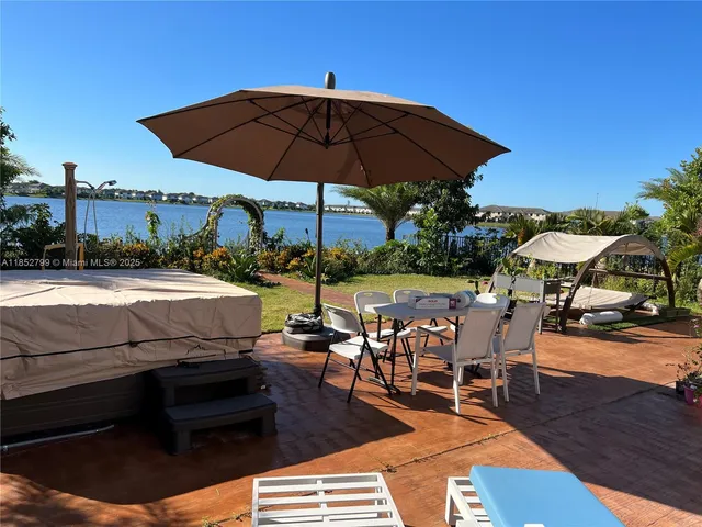 a view of a house with a yard and sitting area