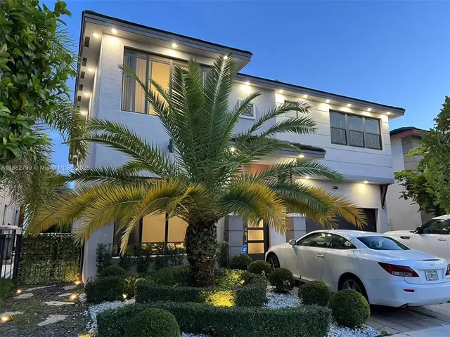 a view of a car park in front of a house