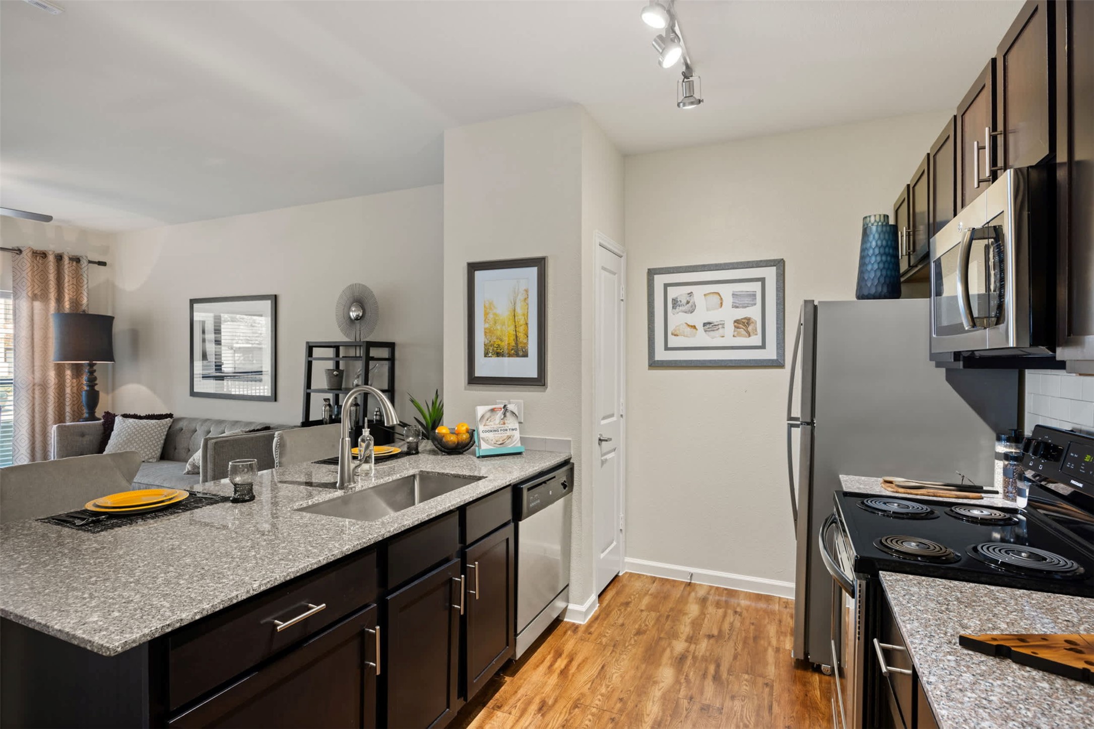 9308 South 1st Beach, Unit 231 Austin, TX 78748 - Photo 8 of 23 a kitchen with stainless steel appliances granite countertop a stove and a sink