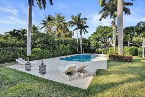 a view of a house with a yard and sitting area