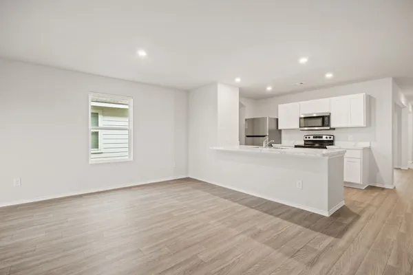 a view of kitchen with wooden floor and electronic appliances