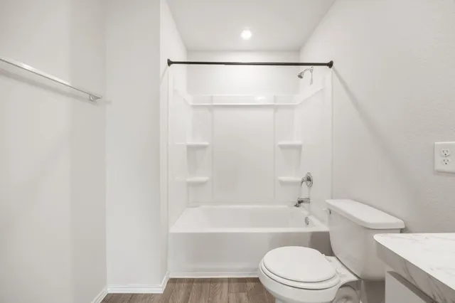 a bathroom with a toilet and a bathtub