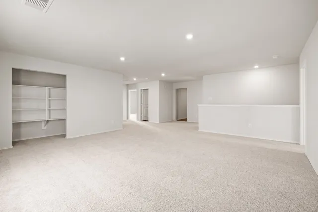 a view of an empty room with a kitchen