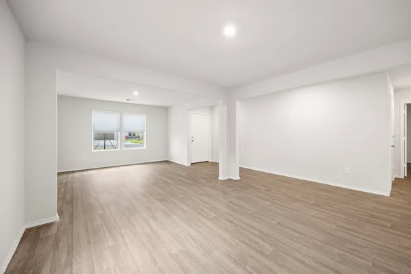 a view of an empty room and wooden floor