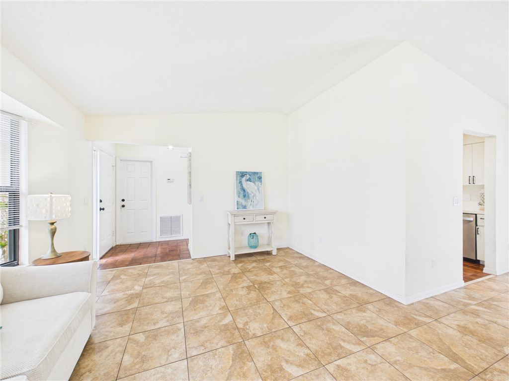 225 Midvale Terrace Sebastian, FL 32958 - Photo 6 of 25 a bedroom with a bed and a couch
