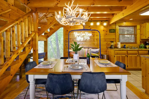 a view of a dining room with furniture and chandelier