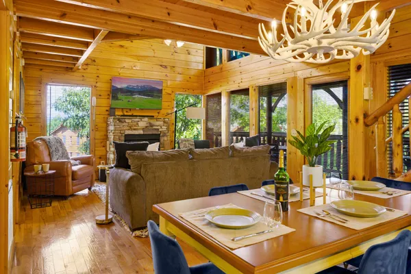 a view of a dining room with furniture a chandelier and wooden floor