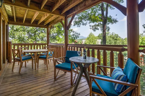 a view of a balcony with furniture and wooden floor