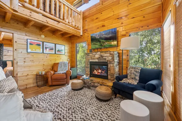a living room with furniture a rug and a fireplace