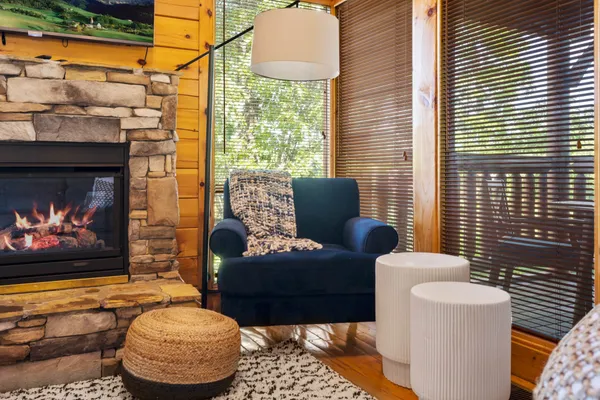 a living room with furniture a rug and a fireplace