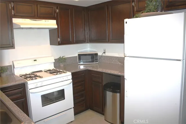 a kitchen with a stove and a refrigerator