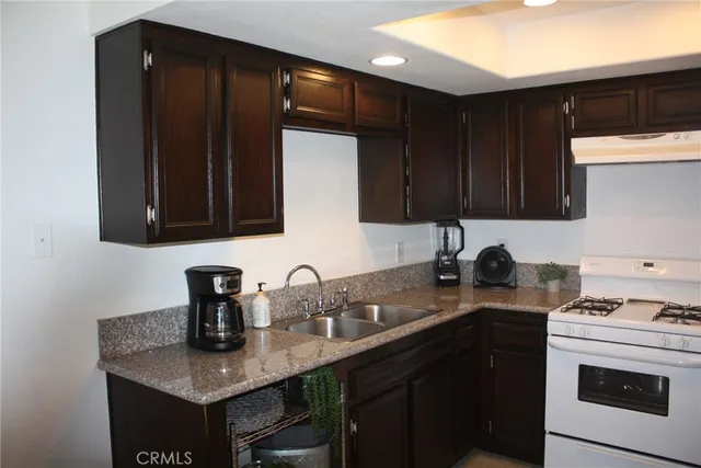 a kitchen with sink a microwave and cabinets