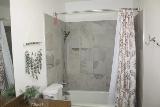 a bathroom with a shower curtain and a sink