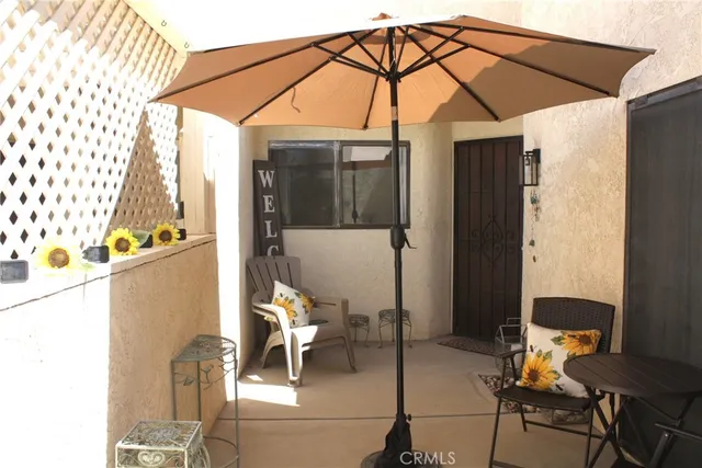 a blue and white umbrella sitting in a bedroom next to a window