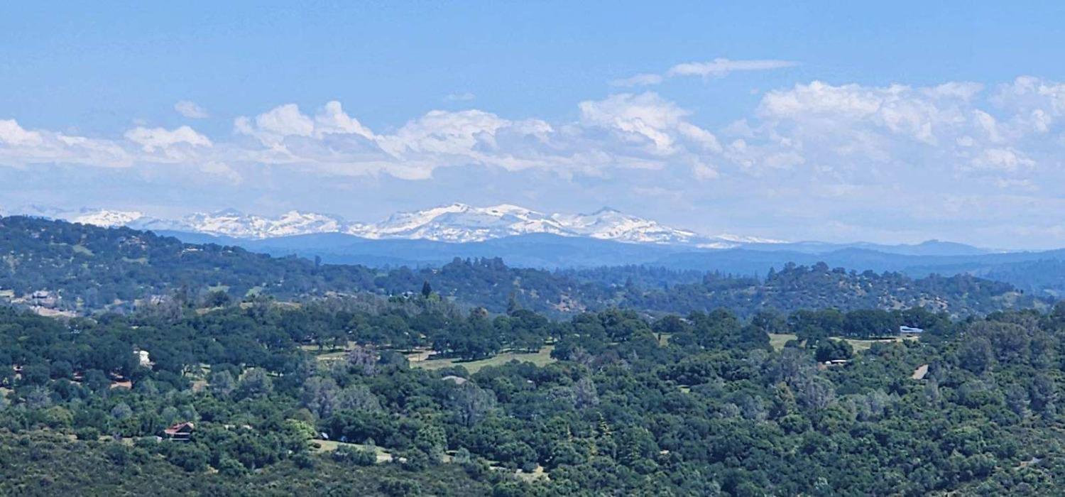 a view of a city and mountains in the background