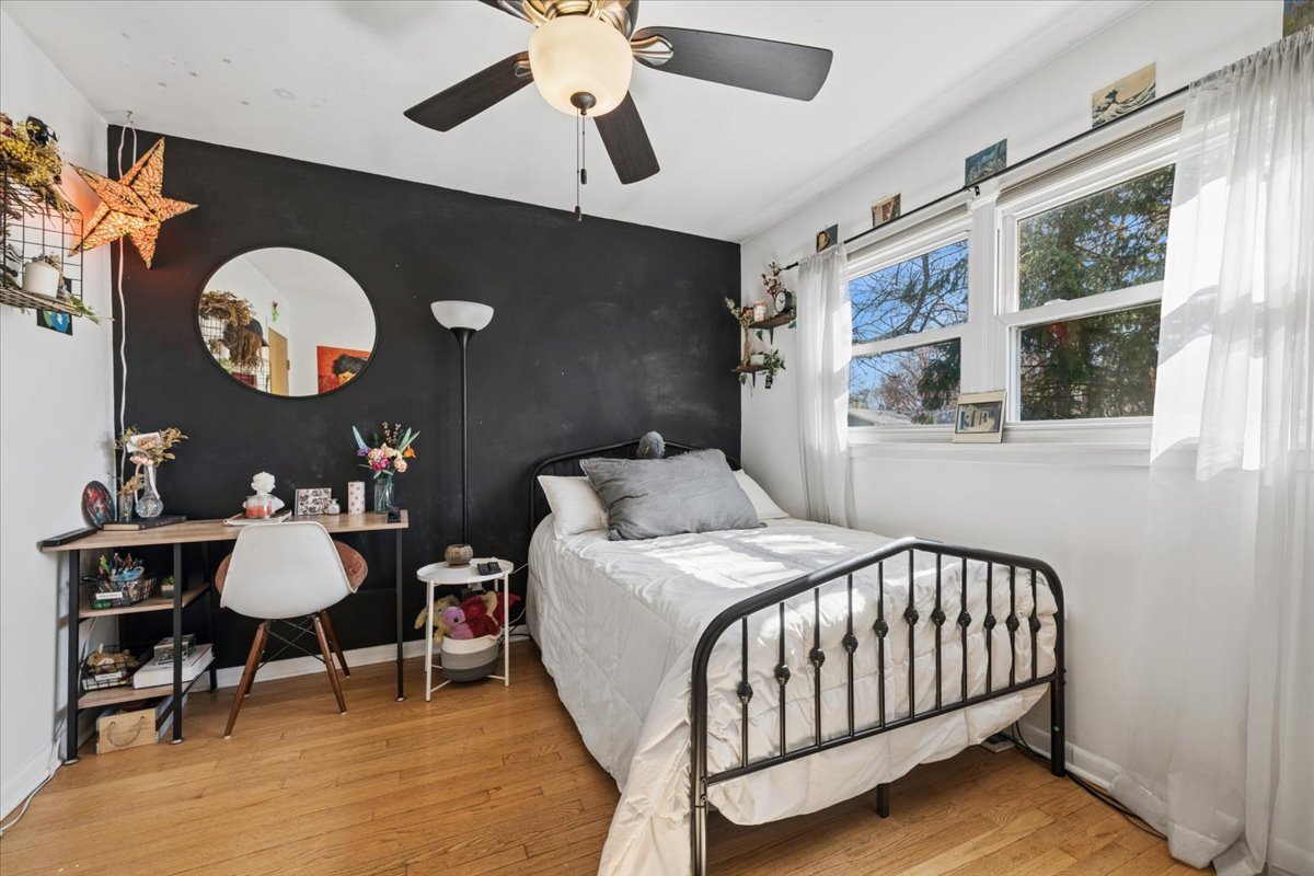 1702 Oak Street St. Charles, IL 60174 - Photo 11 of 20 a bedroom with a bed and a chandelier