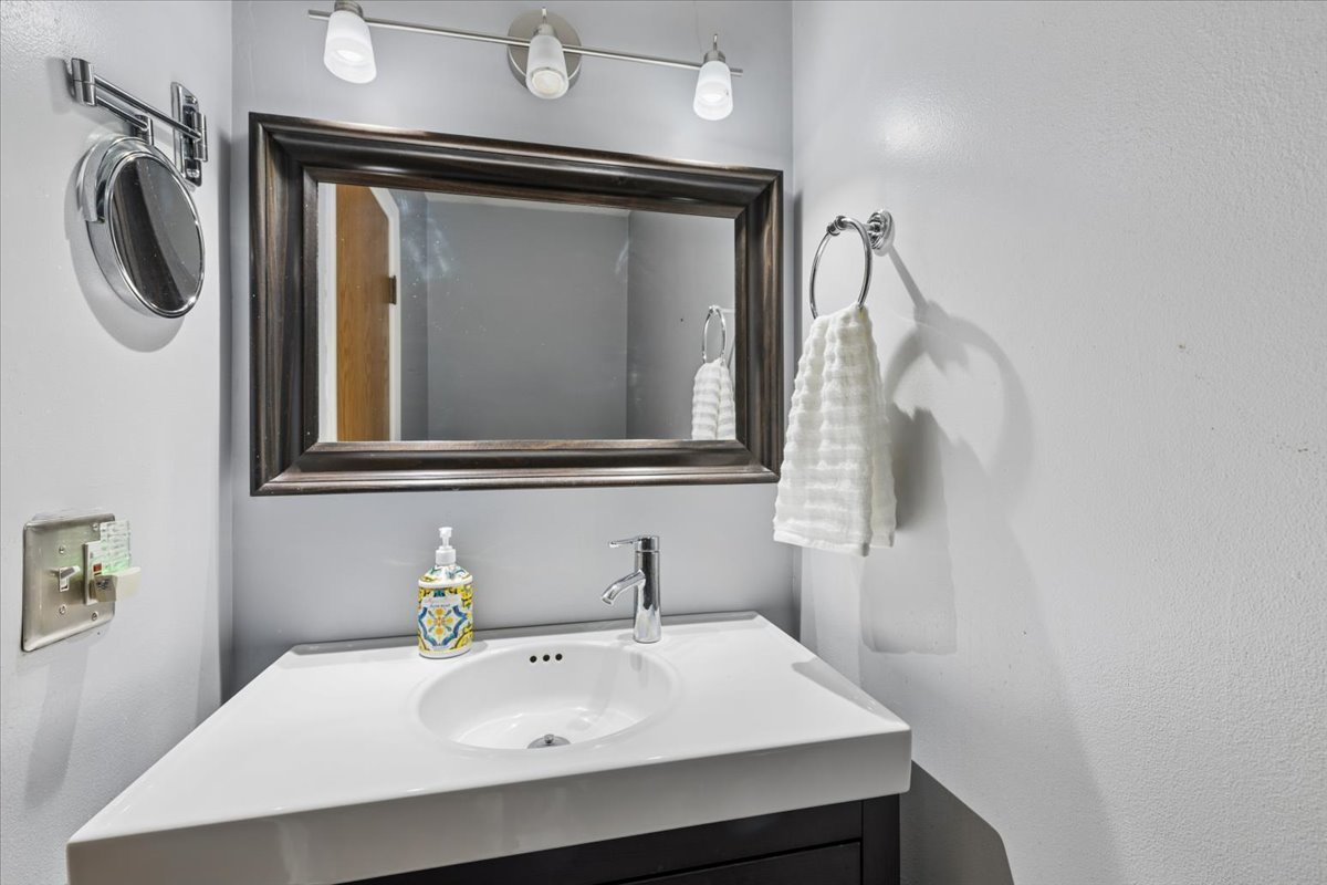 1702 Oak Street St. Charles, IL 60174 - Photo 13 of 20 a bathroom with a sink a mirror and a toilet