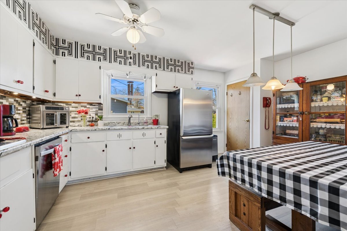 1702 Oak Street St. Charles, IL 60174 - Photo 3 of 20 a kitchen with stainless steel appliances granite countertop a sink a stove and a refrigerator