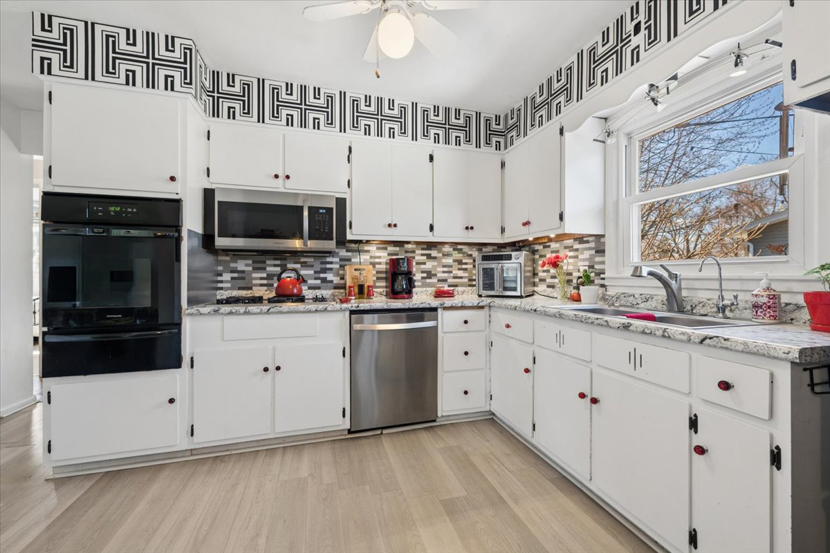 1702 Oak Street St. Charles, IL 60174 - Photo 4 of 20 a kitchen with stainless steel appliances a white cabinets and sink