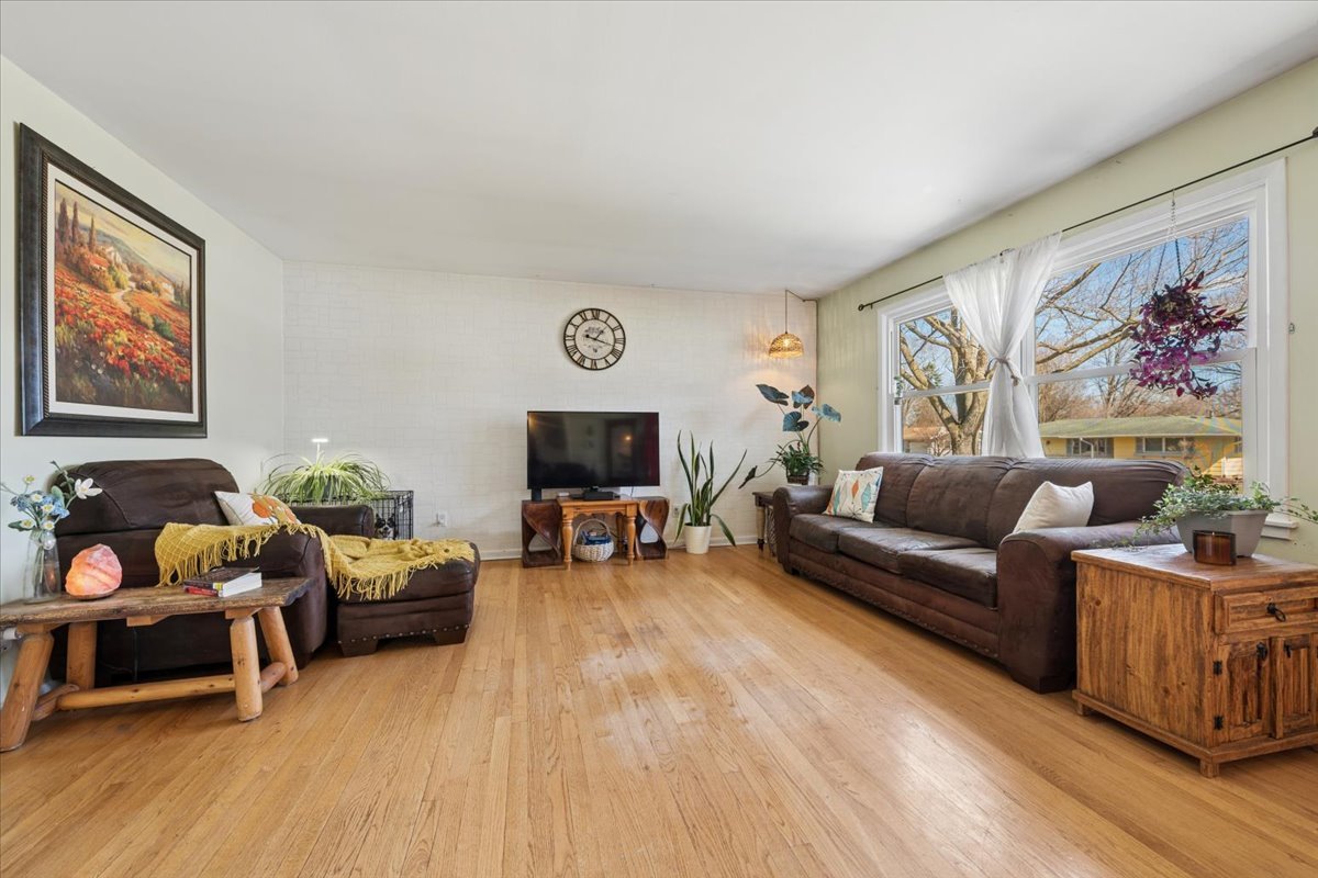 1702 Oak Street St. Charles, IL 60174 - Photo 7 of 20 a living room with furniture a flat screen tv and a fireplace