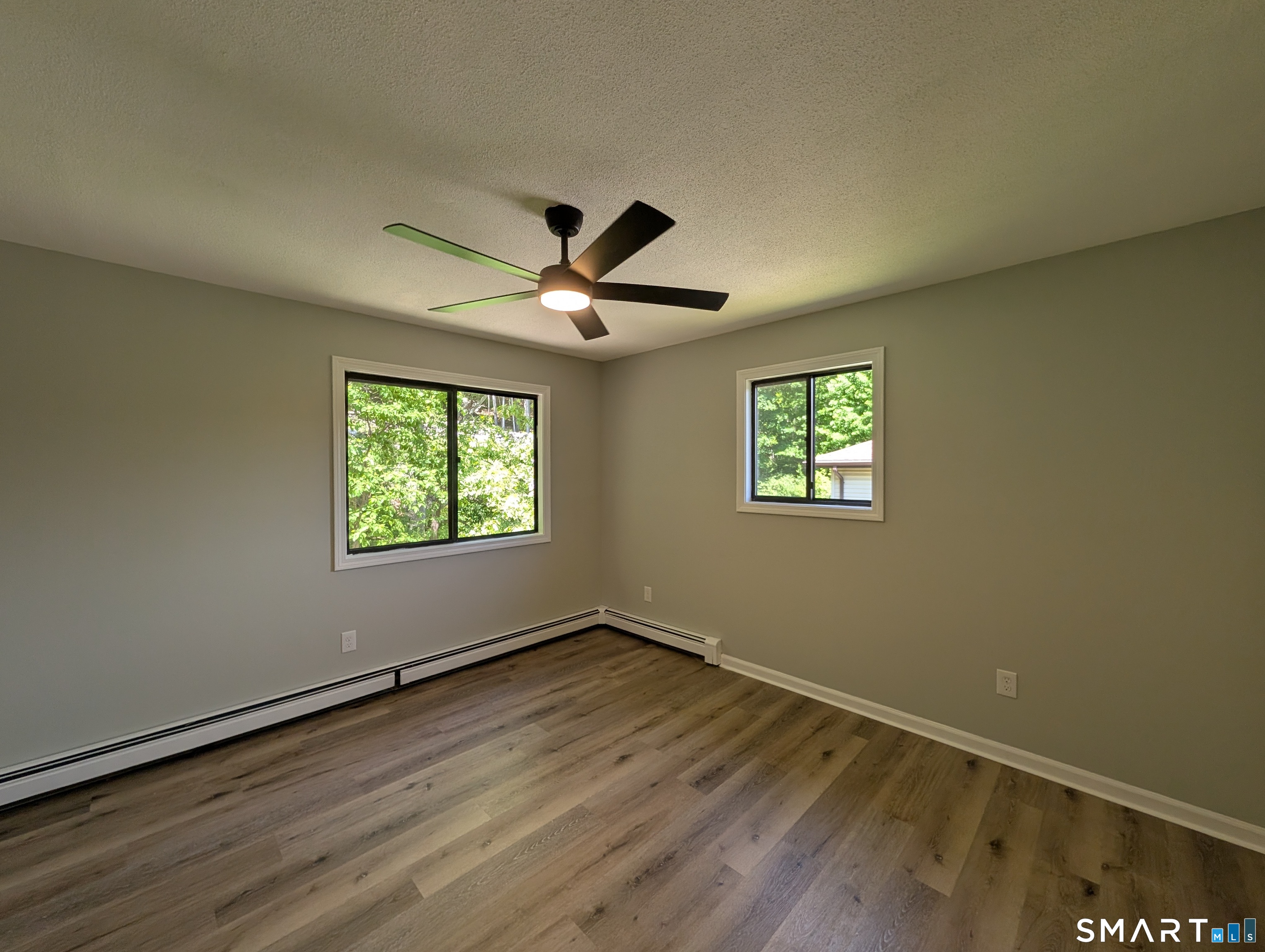 267 Beaver Street Ansonia, CT 06401 - Photo 7 of 12 an empty room with wooden floor and windows