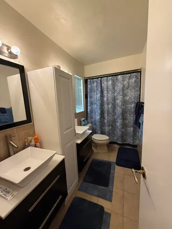 a bathroom with a toilet a sink and mirror