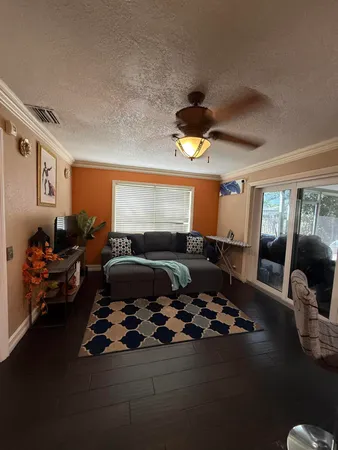 a living room with a couch and wooden floor