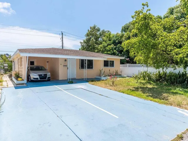 a view of a house with swimming pool and sitting area