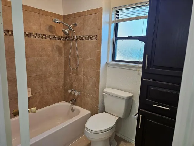 a bathroom with a toilet a sink and bathtub